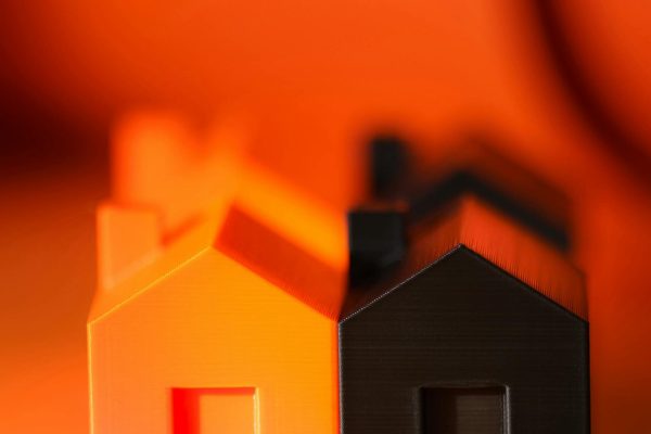 pexels-photo-29175327-29175327 Vibrant and contrasting orange and black miniature house models symbolizing real estate concepts.